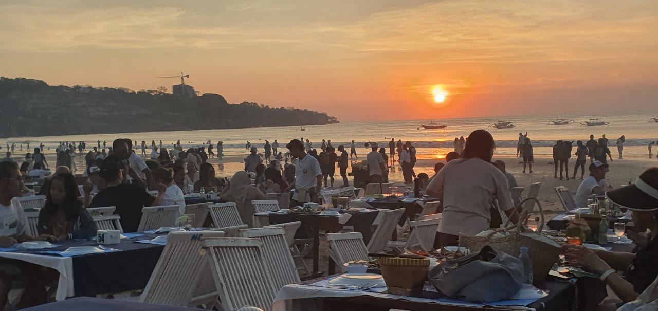 Wisatawan domestik dan mancanegara menikmati sunset di Pantai Jimbaran Bali, Kamis (21/8/2025). (Foto: Alkalifi/Lingkaran.net) 